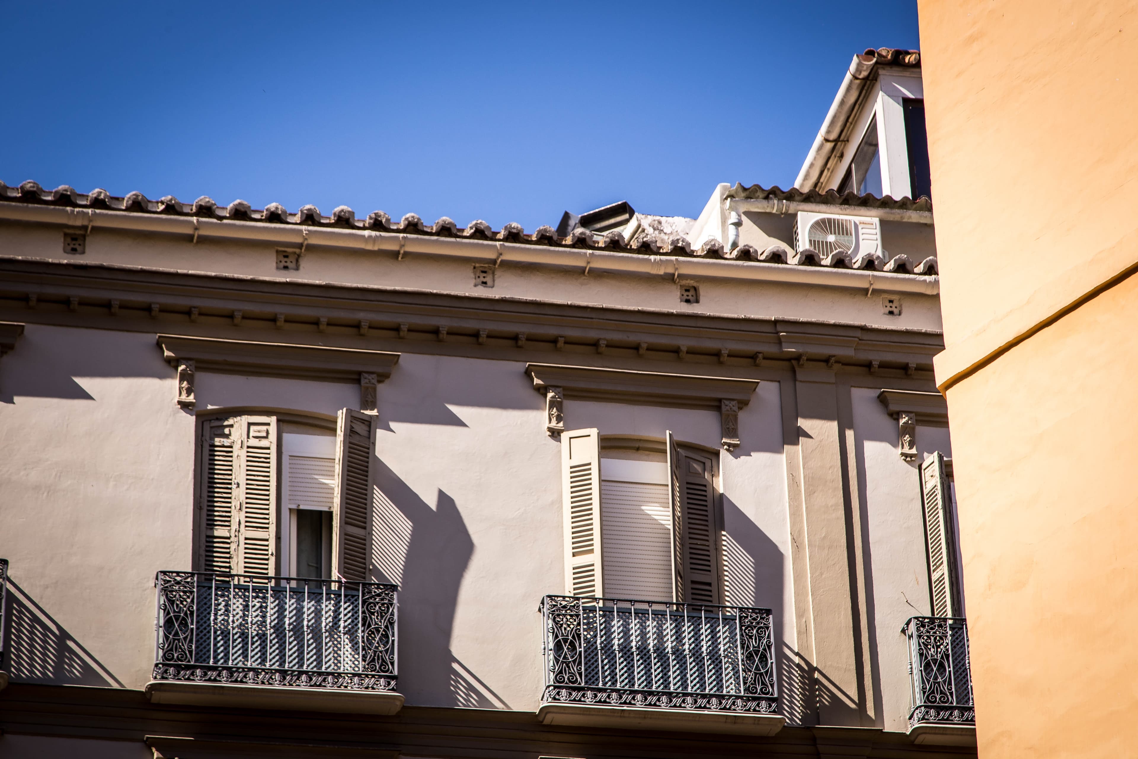 Traditional balconies with washing hung out to dry on a street in Málaga's old town